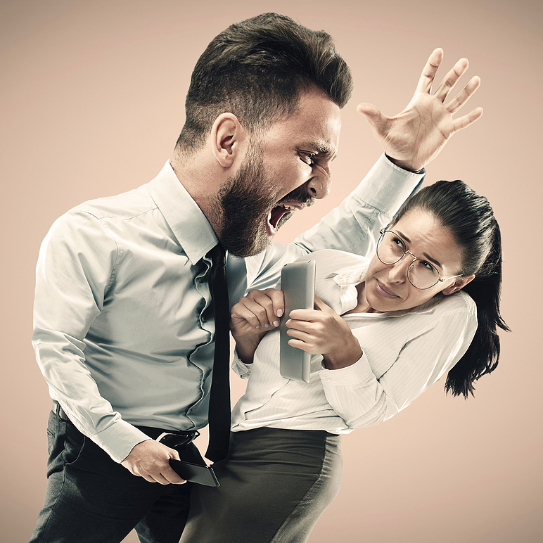 Angry businessman screaming at employee in the office.